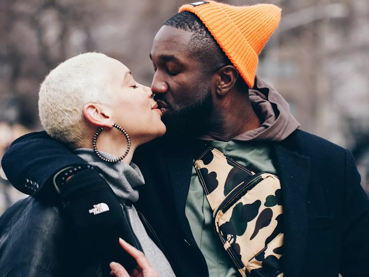 Two people sharing an affectionate moment on a cold day.